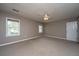 Empty bedroom featuring neutral carpet, a ceiling fan, two windows offering natural light, and a closet door at 750 Lakenheath Dr, Mount Pleasant, SC 29464