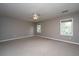 Spacious bedroom with neutral carpet, ceiling fan, two windows offering natural light, and ample open space at 750 Lakenheath Dr, Mount Pleasant, SC 29464