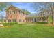 Charming brick home with a manicured front yard, mature trees and professional landscaping at 750 Lakenheath Dr, Mount Pleasant, SC 29464