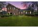 Well-lit brick home features professional landscaping and a manicured front yard at 750 Lakenheath Dr, Mount Pleasant, SC 29464