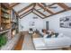 Cozy living room showcasing exposed beams, brick fireplace, hardwood floors, and comfortable seating at 750 Lakenheath Dr, Mount Pleasant, SC 29464