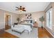 Comfortable bedroom featuring a ceiling fan, hardwood floors, bench, and abundant natural light from a window at 750 Lakenheath Dr, Mount Pleasant, SC 29464