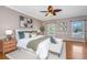 Cozy bedroom featuring hardwood floors, a ceiling fan, a comfortable bed, and abundant natural light from windows at 750 Lakenheath Dr, Mount Pleasant, SC 29464