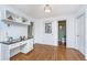 Bright home office with a built-in desk, white cabinetry, a granite countertop, and hardwood flooring at 750 Lakenheath Dr, Mount Pleasant, SC 29464