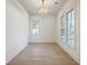 Bright, empty room with natural light, hardwood floors, white trim, and a decorative chandelier at 755 Adluh St, Mount Pleasant, SC 29464