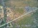 Aerial view of property featuring trees, buildings and a road at 7560 Cottageville Hwy, Round O, SC 29474