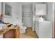 Small bathroom and laundry area with a vanity, toilet, washer, and overhead cabinet at 7560 Cottageville Hwy, Round O, SC 29474
