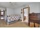 Bedroom with white bed frame, ceiling fan, and doorway leading to the en-suite bathroom at 7560 Cottageville Hwy, Round O, SC 29474