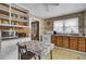 Compact kitchen featuring tiled walls, wood and white cabinets, with an eat-in table at 7560 Cottageville Hwy, Round O, SC 29474