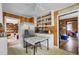 Cozy kitchen with wood paneling, white cabinets, stainless steel refrigerator, and a view into other rooms at 7560 Cottageville Hwy, Round O, SC 29474