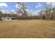 Wide view of property with home, open garage, and large grassy area at 7560 Cottageville Hwy, Round O, SC 29474