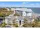 Stunning aerial view of a beachfront condo complex with lush landscaping and ocean access at 9000 Palmetto Dr # G203, Isle of Palms, SC 29451
