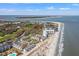 Breathtaking aerial view of condos on the beach with a golf course and a scenic coastal view at 9000 Palmetto Dr # G203, Isle of Palms, SC 29451