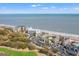 Magnificent aerial of beachfront condos with a community pool, nestled next to a lush golf course at 9000 Palmetto Dr # G203, Isle of Palms, SC 29451