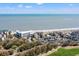 Lovely aerial shot featuring beachfront condos and golf course offering a luxurious coastal lifestyle at 9000 Palmetto Dr # G203, Isle of Palms, SC 29451