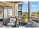 Relaxing balcony with wicker seating, offering a lovely view of the surrounding landscape at 9000 Palmetto Dr # G203, Isle of Palms, SC 29451