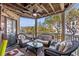 Inviting balcony featuring comfortable wicker furniture, a ceiling fan, and a serene outdoor view at 9000 Palmetto Dr # G203, Isle of Palms, SC 29451