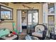 Cozy outdoor balcony with wicker chair and table, offering a glimpse into the bedroom at 9000 Palmetto Dr # G203, Isle of Palms, SC 29451