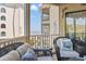 Charming balcony with wicker furniture, providing a serene ocean view at 9000 Palmetto Dr # G203, Isle of Palms, SC 29451