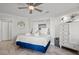Bedroom features a queen bed with white linens, nautical decor, and tile flooring at 9000 Palmetto Dr # G203, Isle of Palms, SC 29451