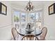 Bright breakfast nook with a decorative chandelier and a bay window overlooking the outdoor area at 9000 Palmetto Dr # G203, Isle of Palms, SC 29451