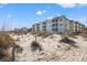 Beachfront condos with balconies overlooking dunes and ocean offer a relaxing coastal living experience at 9000 Palmetto Dr # G203, Isle of Palms, SC 29451