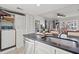Well-equipped kitchen with modern appliances, adjacent to a laundry closet and an open living space at 9000 Palmetto Dr # G203, Isle of Palms, SC 29451