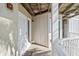 View of the covered patio showing a view of a welcome mat and wood paneling on walls and ceiling at 9000 Palmetto Dr # G203, Isle of Palms, SC 29451