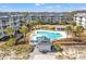Aerial view of a community pool with hot tub, beach access, and lounge chairs for relaxing in the sun at 9000 Palmetto Dr # G203, Isle of Palms, SC 29451