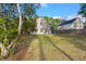 View of house and backyard with mature landscaping at 9116 Fieldstone Trace, Summerville, SC 29485