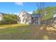 Exterior view of house and screened porch with backyard at 9116 Fieldstone Trace, Summerville, SC 29485