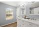 Bright bathroom features a double sink vanity, modern lighting, and a large window with natural light at 9116 Fieldstone Trace, Summerville, SC 29485