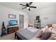 Bedroom with neutral walls, ceiling fan, TV, and modern furnishings provides a comfortable living space at 9116 Fieldstone Trace, Summerville, SC 29485