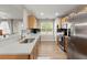 Bright kitchen showcases stainless steel appliances, wood cabinets, and ample counter space with backsplash at 9116 Fieldstone Trace, Summerville, SC 29485