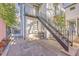 Backyard showcasing a stone patio, stairs to a balcony, and outdoor space for entertaining at 10 Humphrey Ct, Charleston, SC 29403
