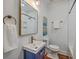 Stylish bathroom with a navy blue vanity, gold accents, and modern fixtures at 10 Humphrey Ct, Charleston, SC 29403