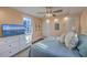 Comfortable bedroom featuring a large TV, ceiling fan, and bright window at 10 Humphrey Ct, Charleston, SC 29403