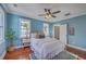 Bedroom featuring blue walls, hardwood floors, a ceiling fan and view to ensuite bathroom at 10 Humphrey Ct, Charleston, SC 29403