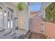 Charming home entrance with a pink door, brick path, and lush greenery at 10 Humphrey Ct, Charleston, SC 29403