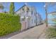 Charming exterior showcasing white siding, a pink gate, second story balcony, and well-maintained street at 10 Humphrey Ct, Charleston, SC 29403