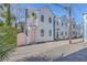 A charming white house with a pink door and balcony, showcasing its unique architectural style at 10 Humphrey Ct, Charleston, SC 29403