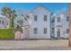Charming white two-story home featuring a pink door, lush landscaping, and a balcony at 10 Humphrey Ct, Charleston, SC 29403