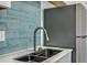 A modern sink and tile backsplash are the focal point in this updated kitchen at 10 Humphrey Ct, Charleston, SC 29403