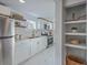 Stylish kitchen with white cabinets, gold hardware, stainless steel appliances, and marble floors at 10 Humphrey Ct, Charleston, SC 29403