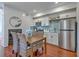 Bright eat-in kitchen with stainless steel appliances and dining table with seating for four at 10 Humphrey Ct, Charleston, SC 29403