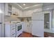 Vintage kitchen with white cabinets and appliances, showcasing a traditional design and layout at 10 Humphrey Ct, Charleston, SC 29403