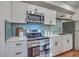 Updated kitchen with stainless steel appliances, white cabinets, tile backsplash, and a clean aesthetic at 10 Humphrey Ct, Charleston, SC 29403