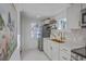 Bright kitchen with white cabinetry, stainless steel appliances, a gold faucet, and marble flooring at 10 Humphrey Ct, Charleston, SC 29403