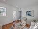 Sunlit living room with hardwood floors, neutral decor, and a view of the doorway with bright natural light at 10 Humphrey Ct, Charleston, SC 29403