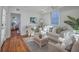 Bright living room with hardwood floors, white walls, and comfortable seating, leading to bedroom through french doors at 10 Humphrey Ct, Charleston, SC 29403